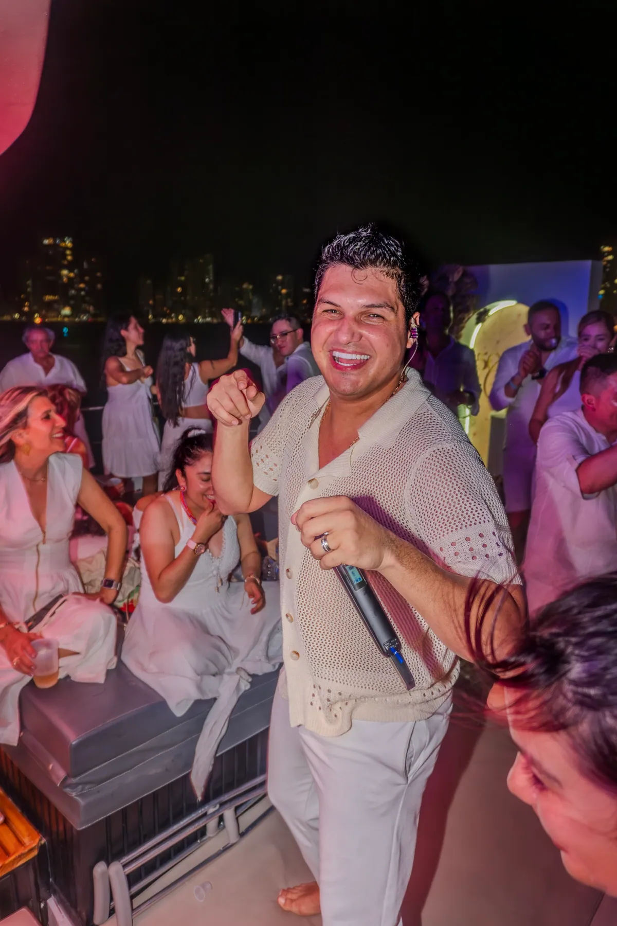 Performer celebrating with guests during an onboard party