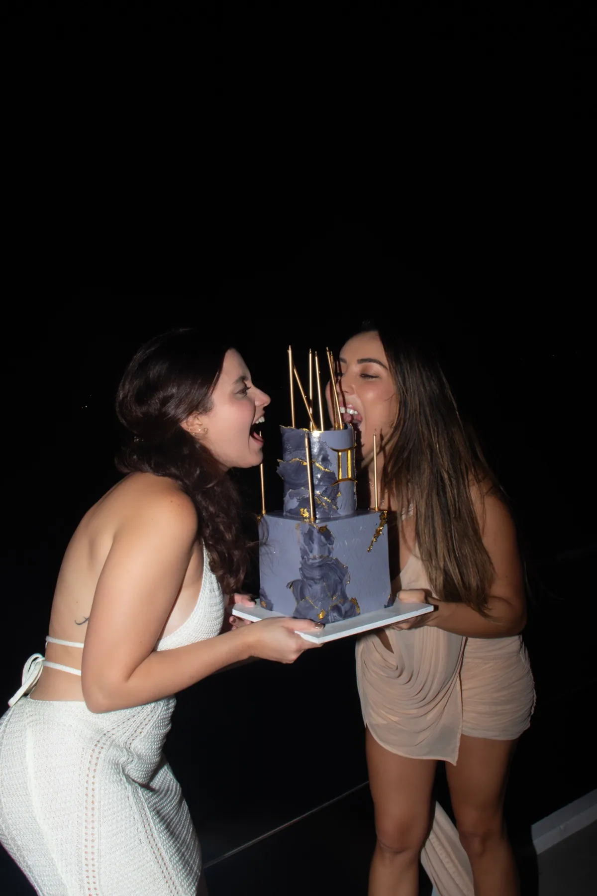 Friends celebrating with a cake onboard Mavi Soul