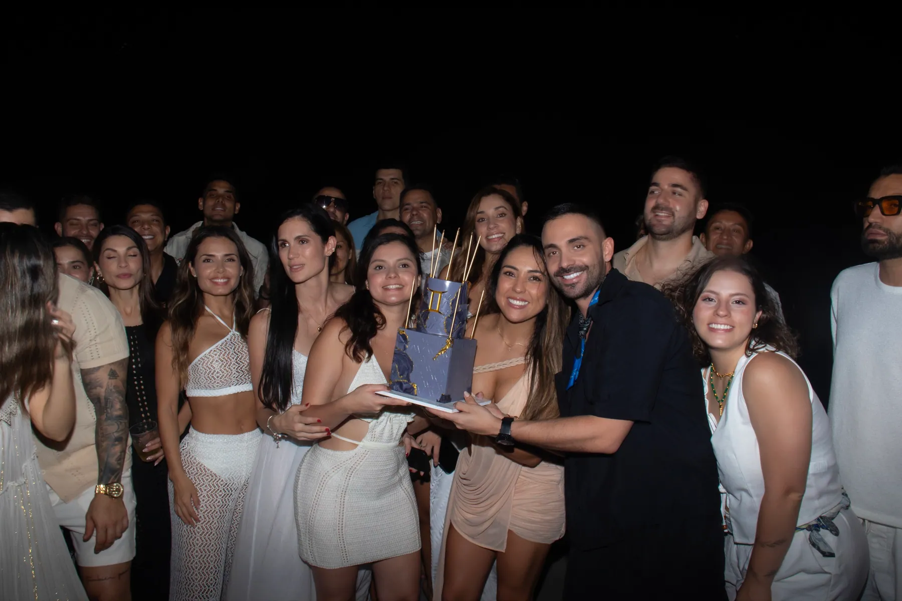 Group celebrating a special occasion with a cake onboard