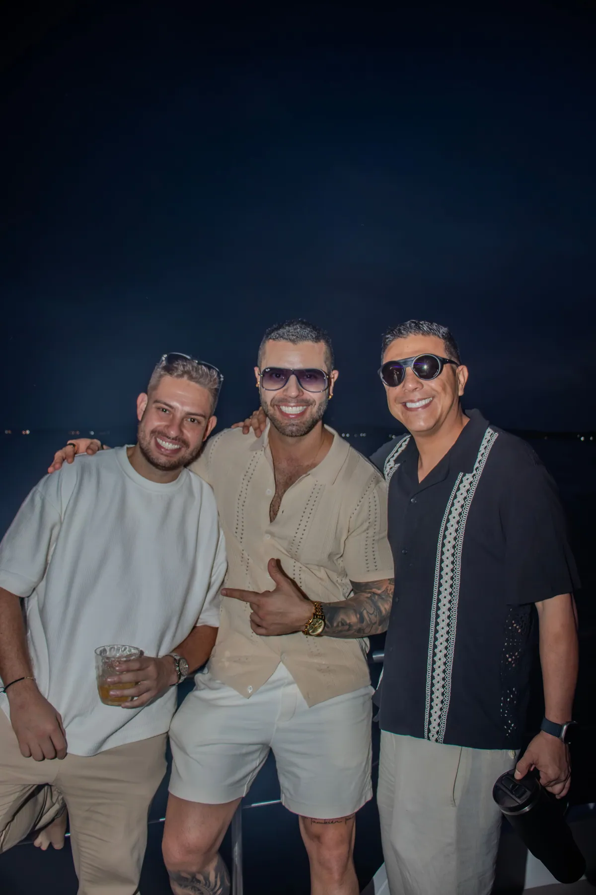 Friends posing together during an evening event